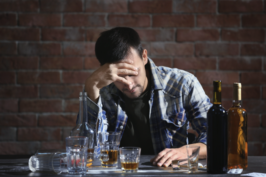 Alcoholic man experiencing alcohol withdrawal symptoms.